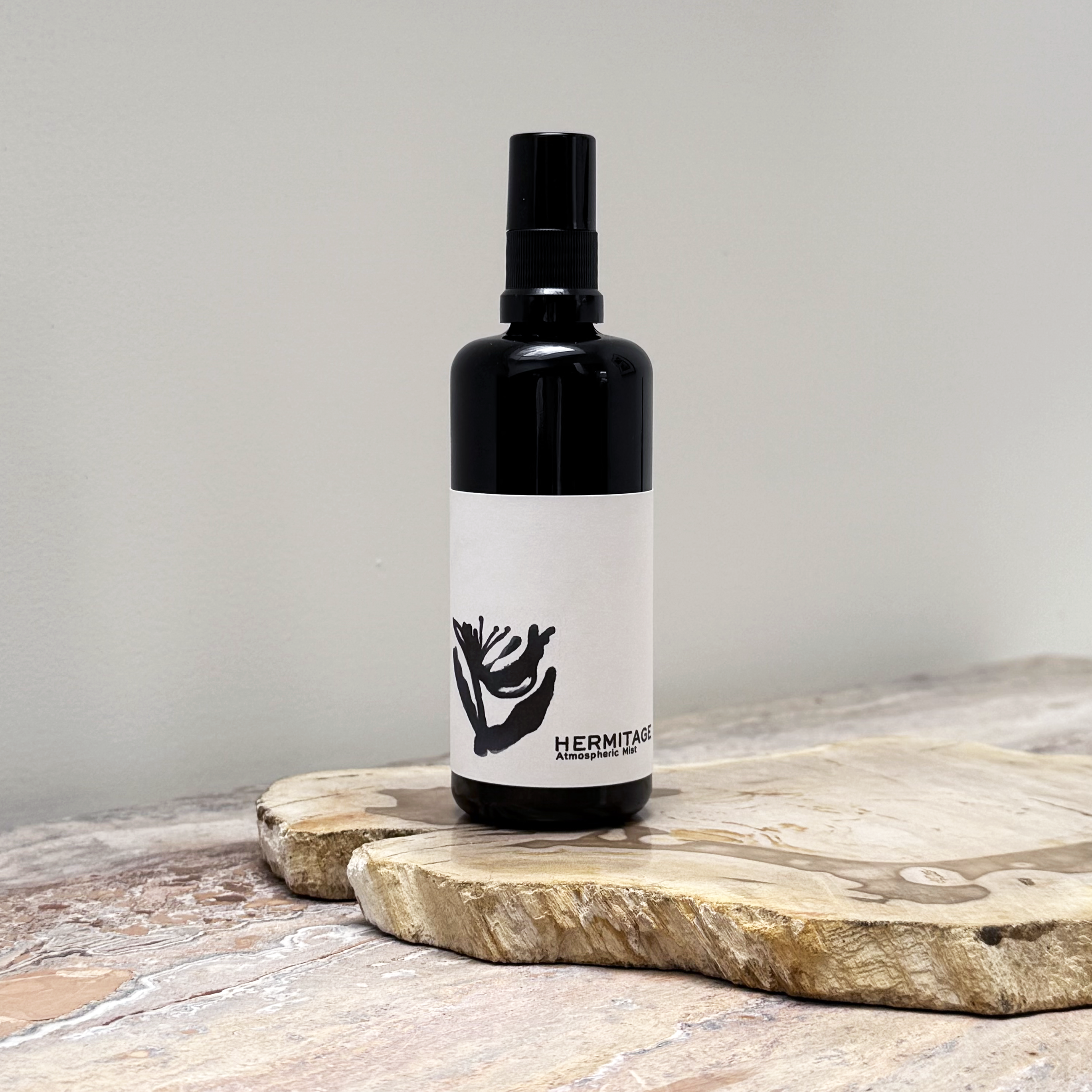 Black bottle with a white label on a wooden surface
