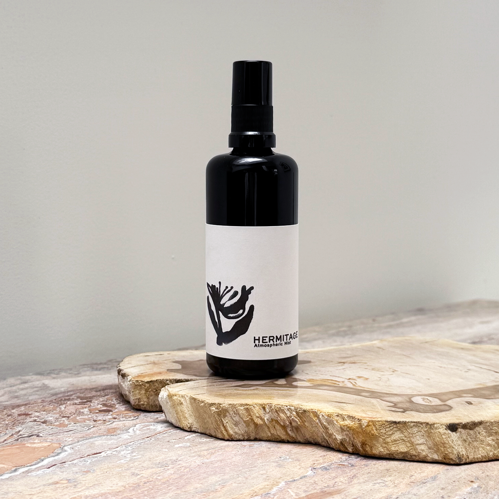 Black bottle with a white label on a wooden surface