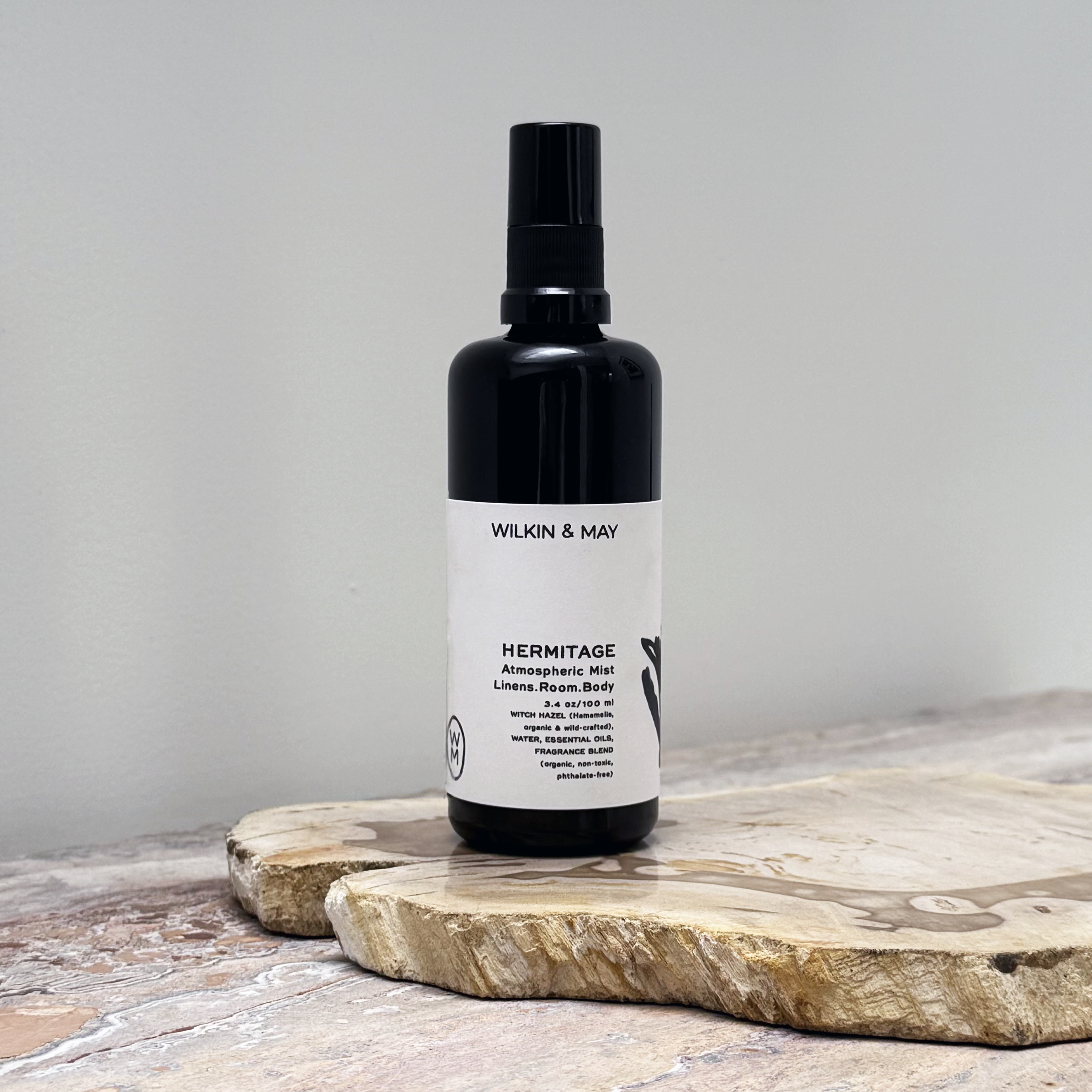 Black bottle with white label on a wooden surface