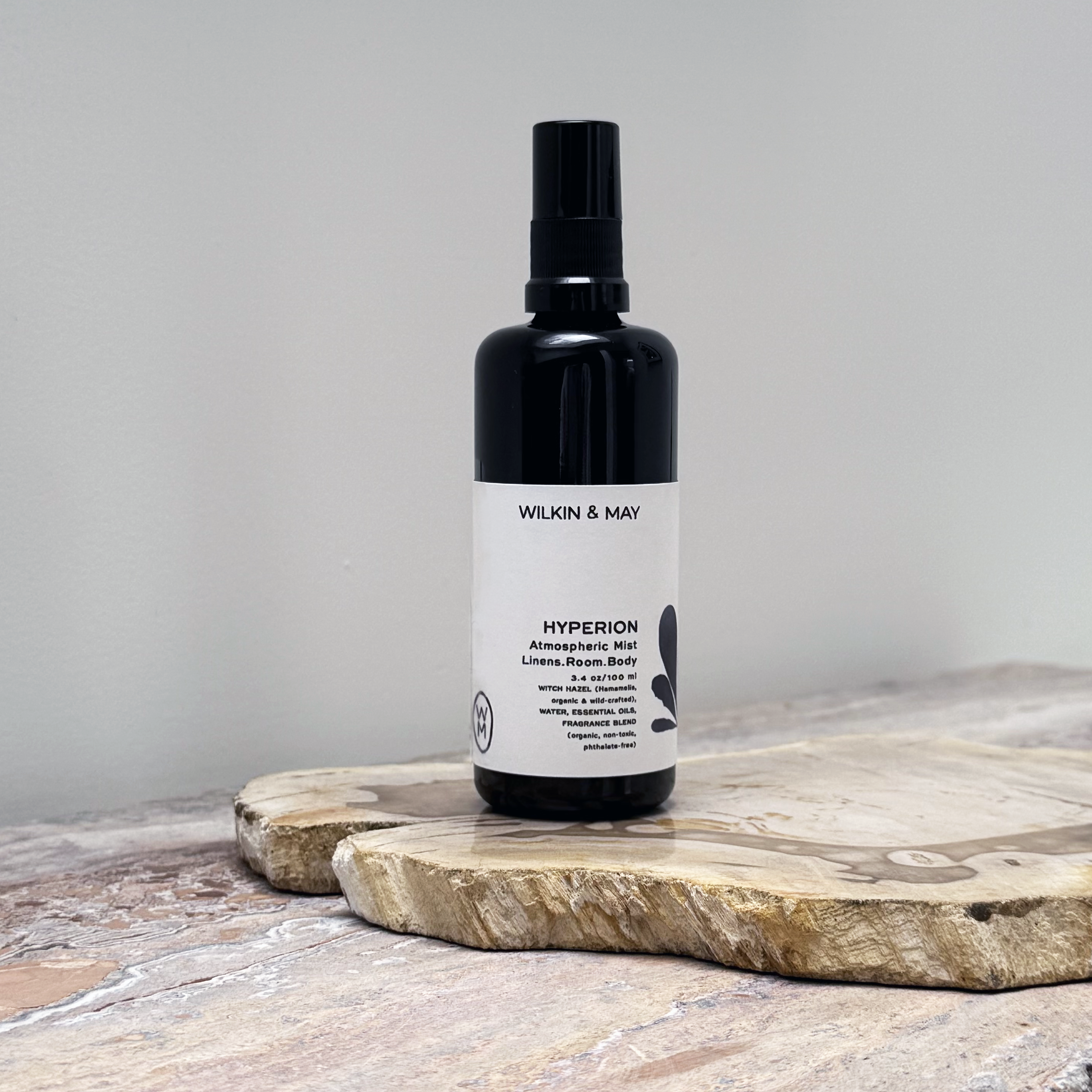 Black bottle with white label on a wooden surface