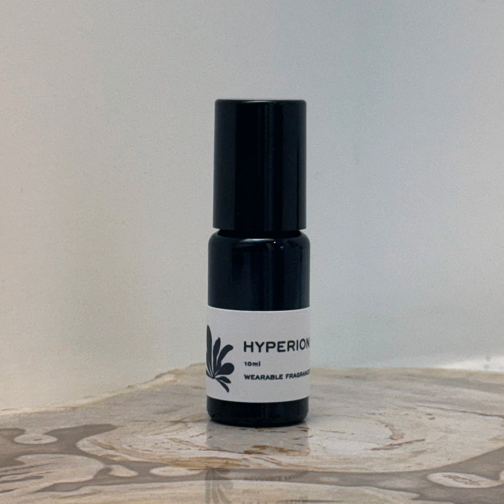 Small black and white bottle labeled 'HYPERION' on a marble surface with a light gray background